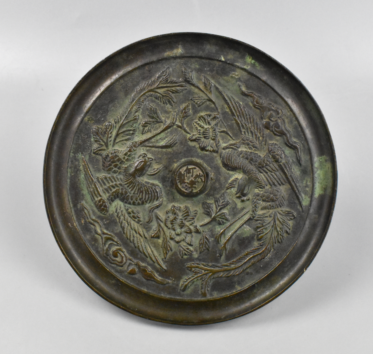 A Chinese bronze mirror with Phoenix dating from the 17