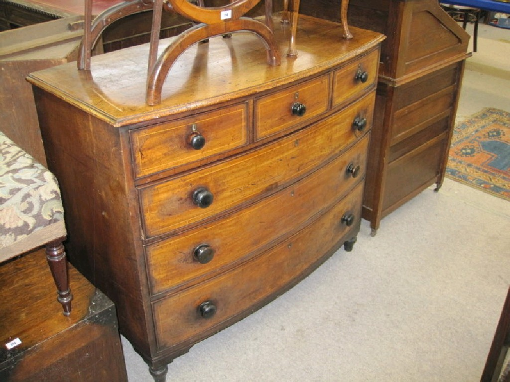 String inlaid oak bow front chest with three small drawers