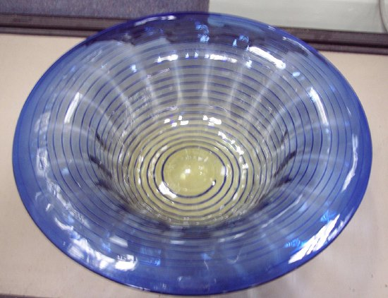A blue glass dish with trailed spiral decoration 31cm 12