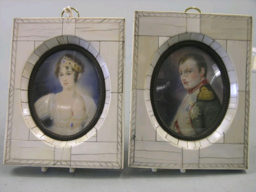 A pair of portrait miniatures within ivory frames portrait busts