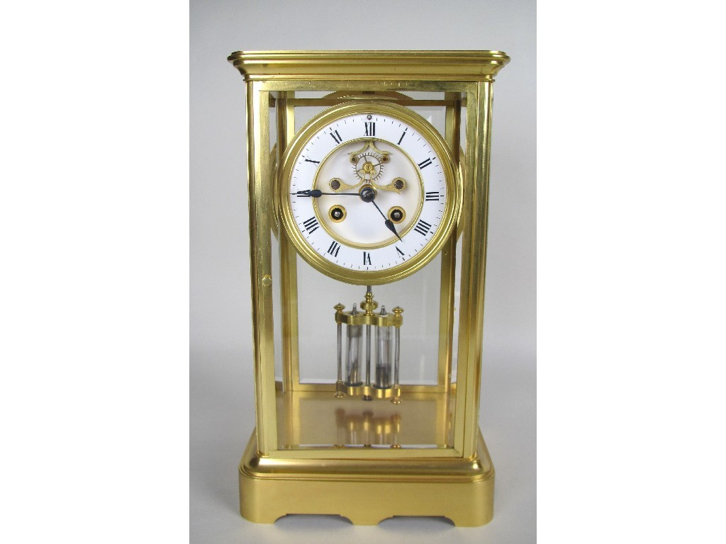 A Victorian gilt brass mantel clock with bevelled glass panels