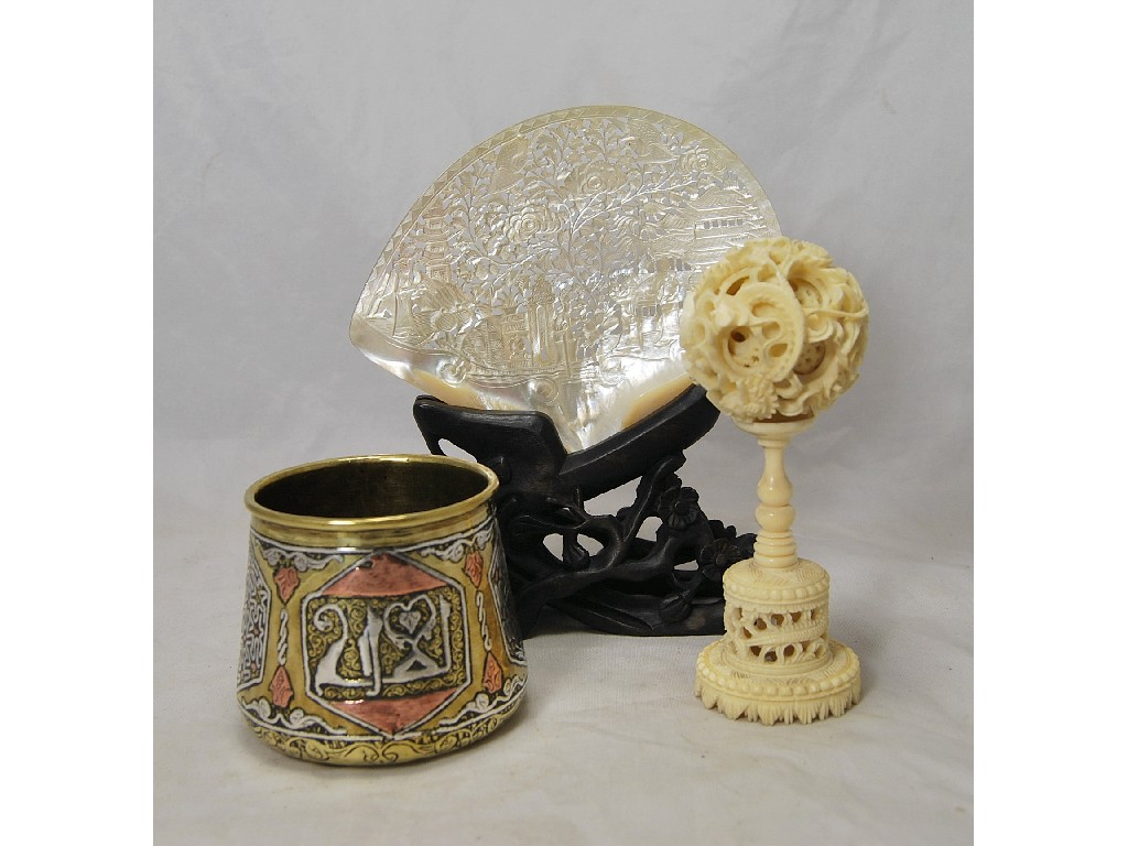 A Chinese carved ivory puzzle ball on turned stem a