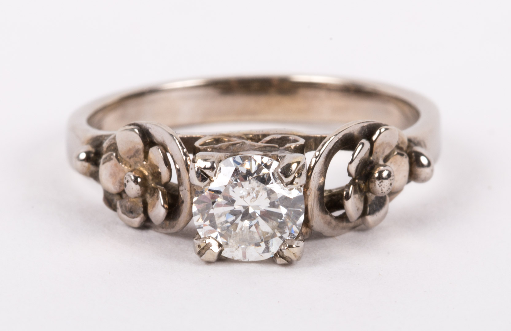 A Diamond Ring 18k white gold mounting contains a center