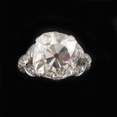 An impressive diamond solitaire ring the cushion shaped diamond weighs