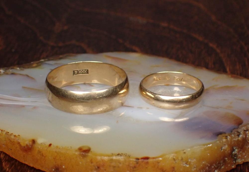 HIS AND HERS FOURTEEN KARAT GOLD WEDDING BANDS including a