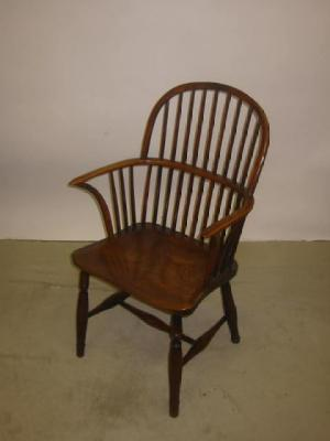 A YEW WINDSOR ARM CHAIR of hooped stick back form