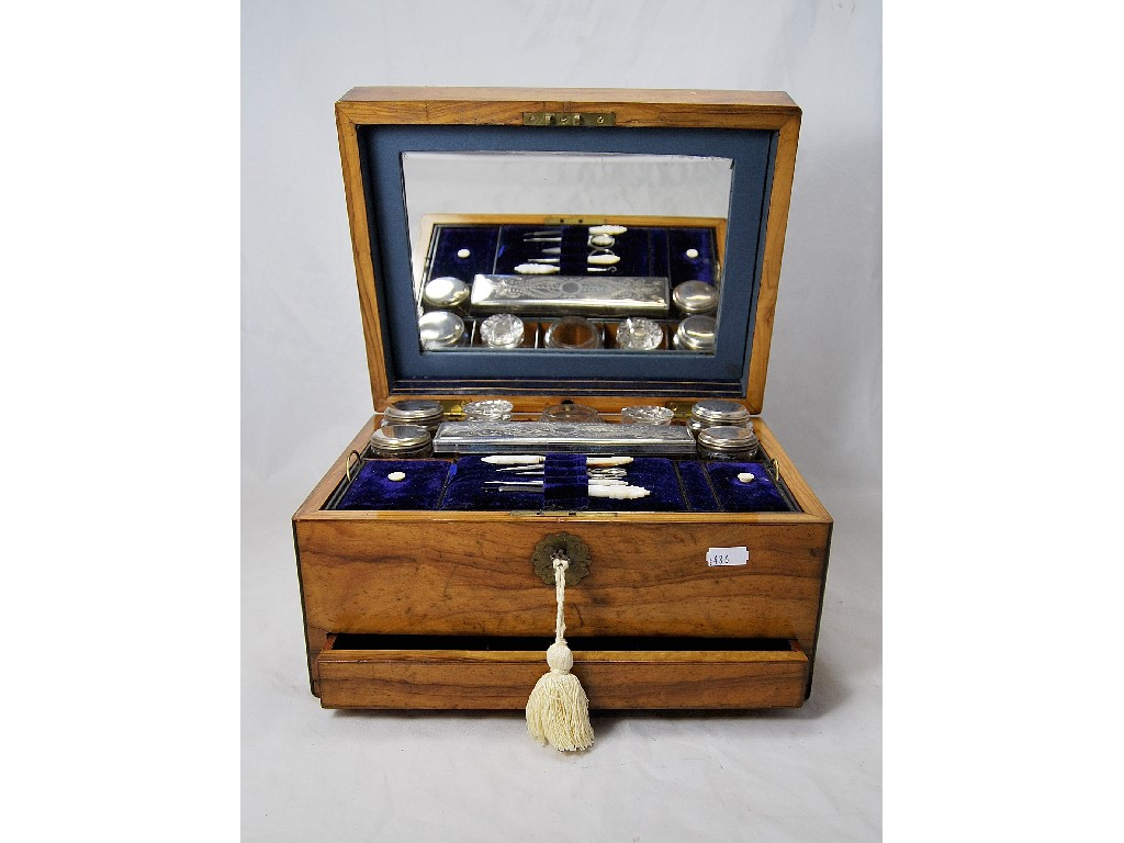 A Victorian walnut travelling toilet case fitted with cut glass