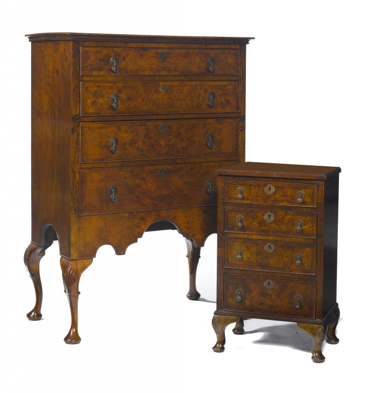 A WALNUT CHEST OF DRAWERS with quarter veneered top fitted