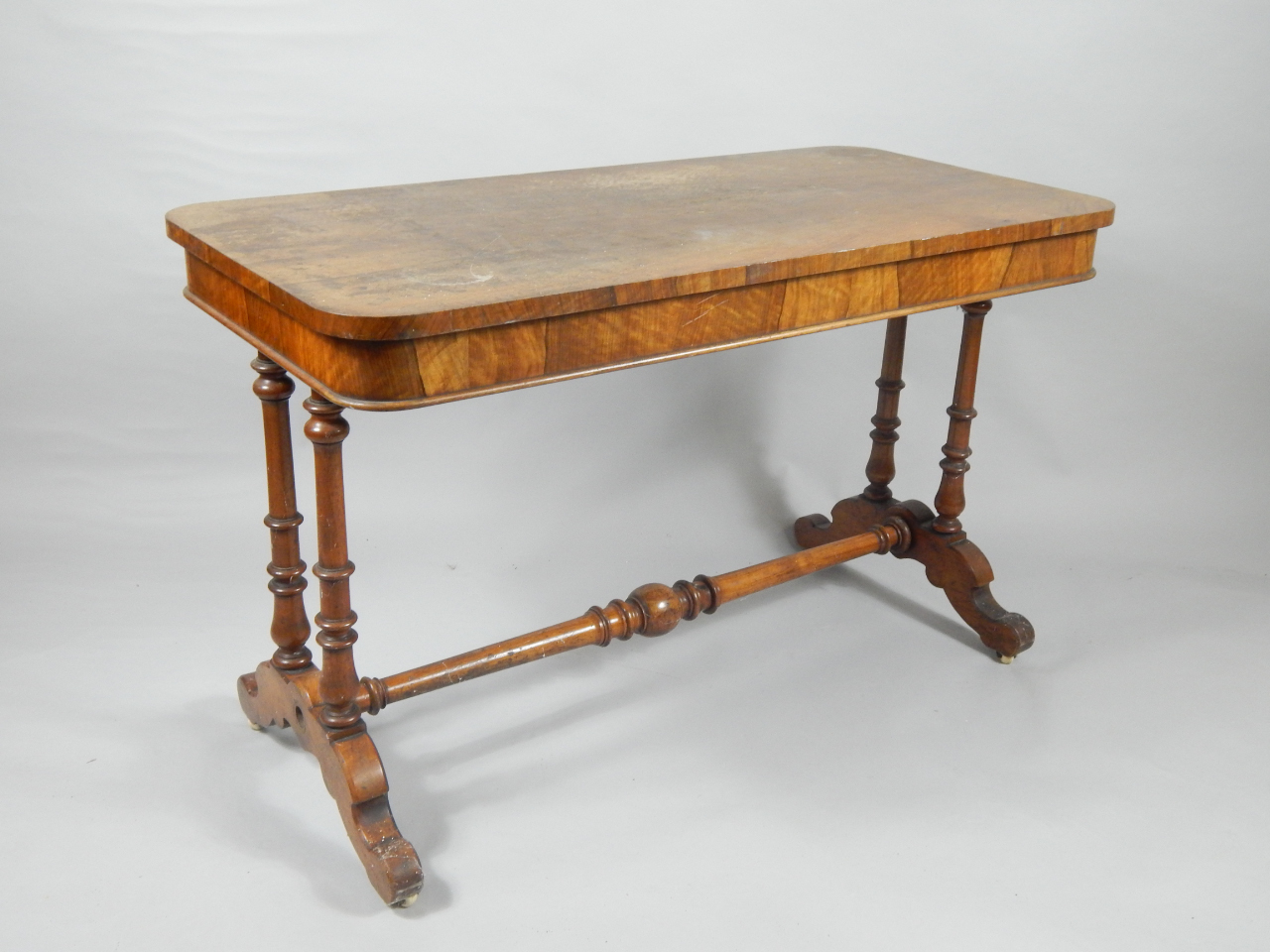 A Victorian walnut library table the rectangular top with two