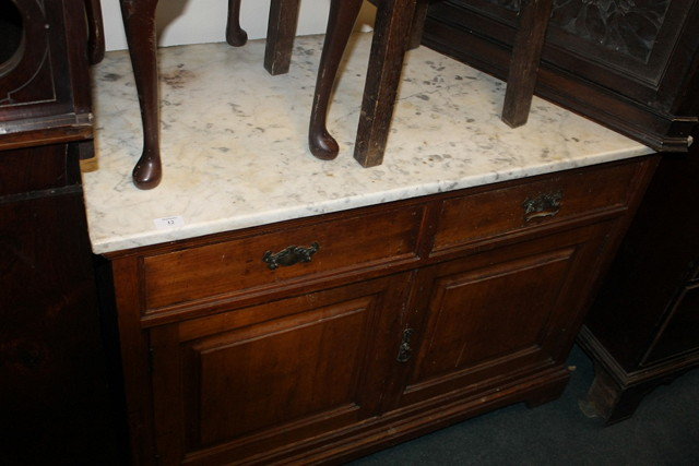 AN EDWARDIAN SATIN WOOD WALNUT CUPBOARD with an arrangement of