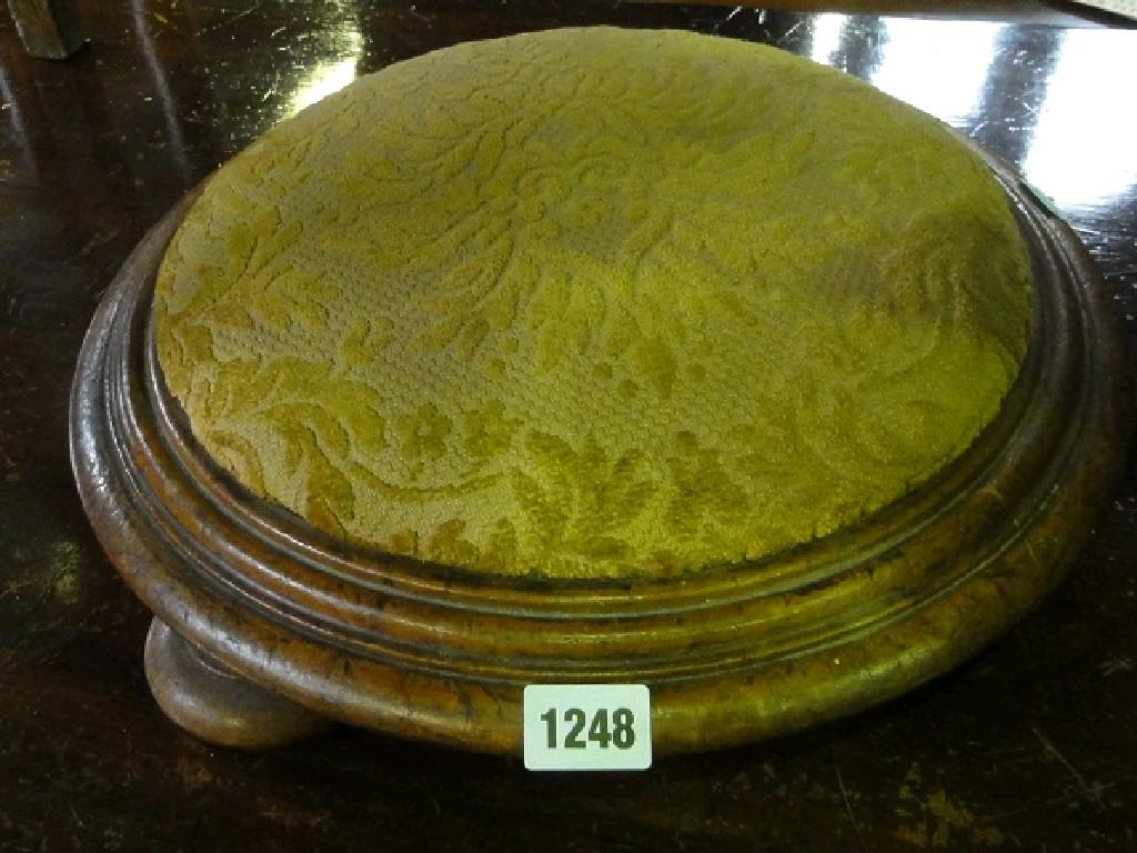 A Victorian mahogany foot stool of circular form with cut