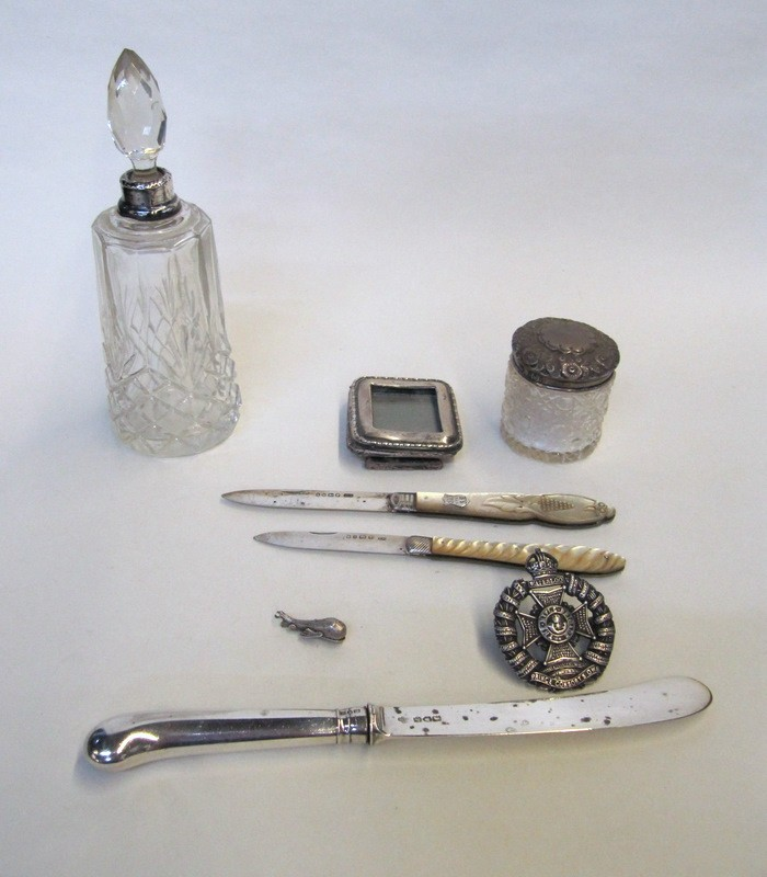 Lot comprising a silver military badge a scent bottle silver