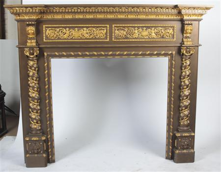 A 19th century carved and overpainted pine chimneypiece of inverted