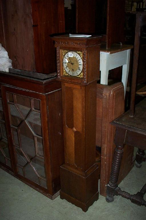 An oak grandmother clock with applied spiral twist decoration and