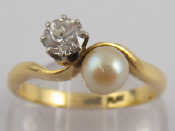 A yellow metal tests 18 carat gold diamond and untested