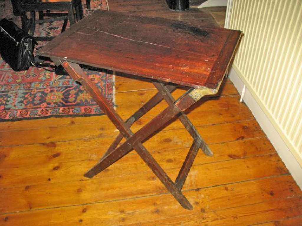 A MAHOGANY COACHING TABLE with brass mounts and a folding