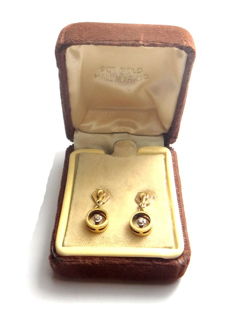 A pair of 9ct gold and diamond set single stone