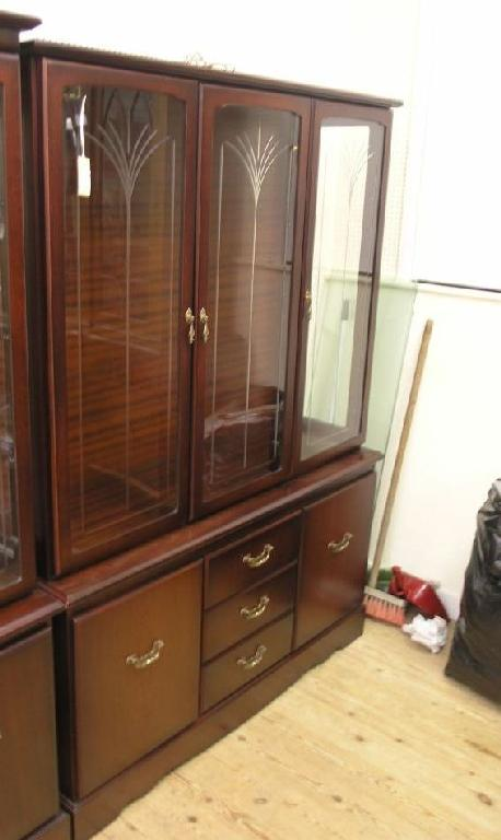 A modern mahogany wall unit two glass shelves enclosed by