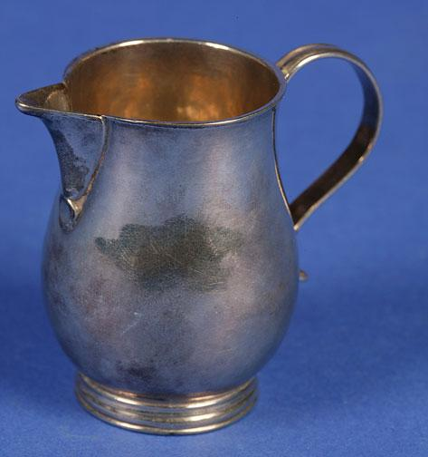 A GEORGE II SPARROWBEAK CREAM JUG of baluster form with
