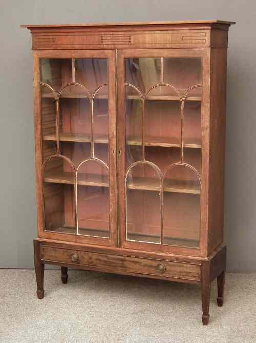 An Edwardian mahogany bookcase on stand the moulded cornice with