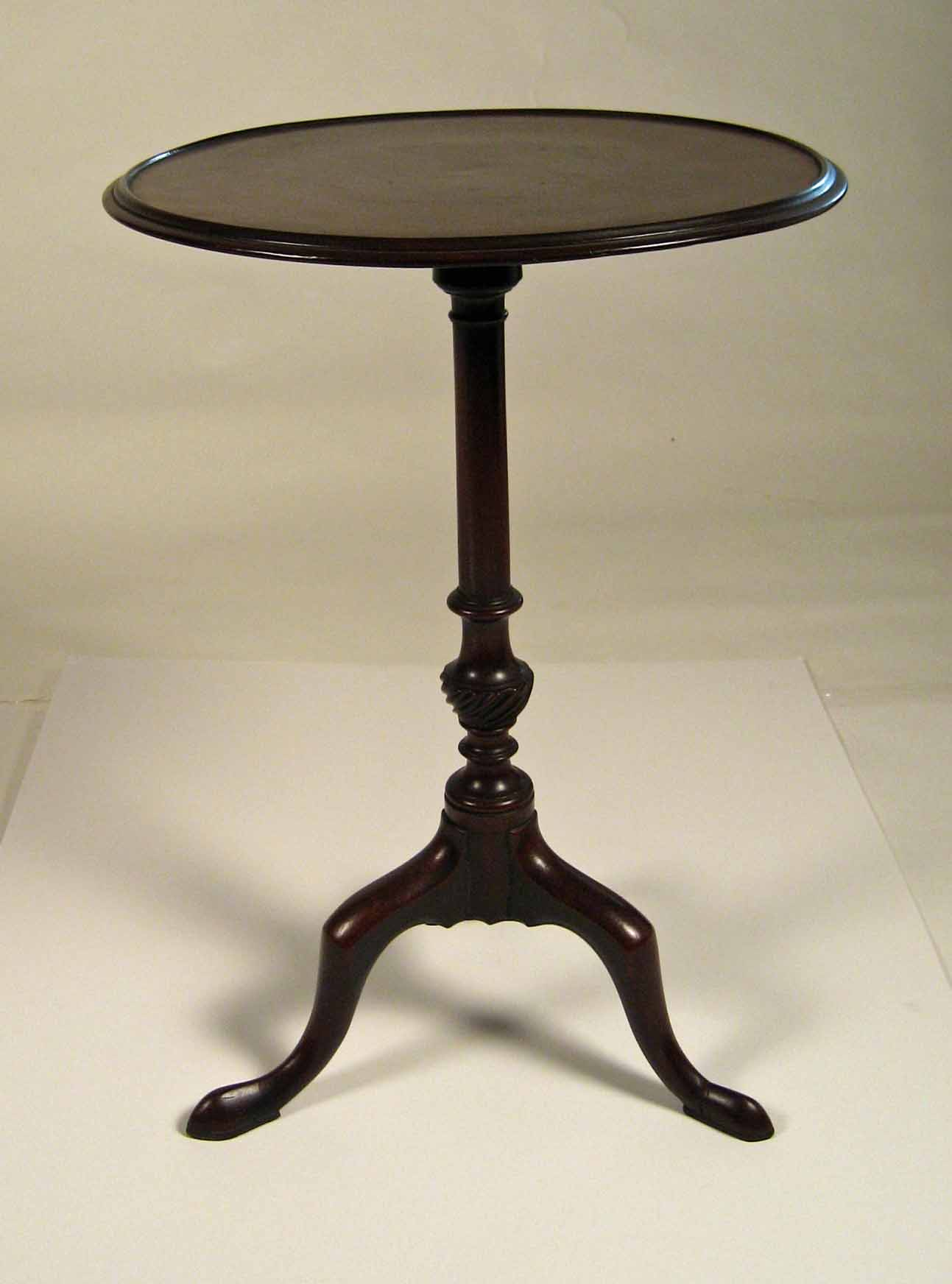 English mahogany candlestand The circular dished top raised on a