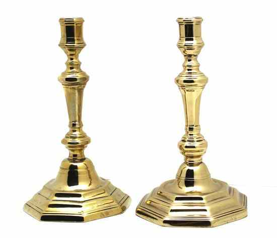 A Pair of Brass Candlesticks each raised on an octagonal