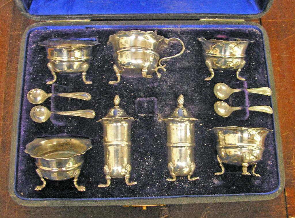 A silver cruet comprising four salts two peppers and a