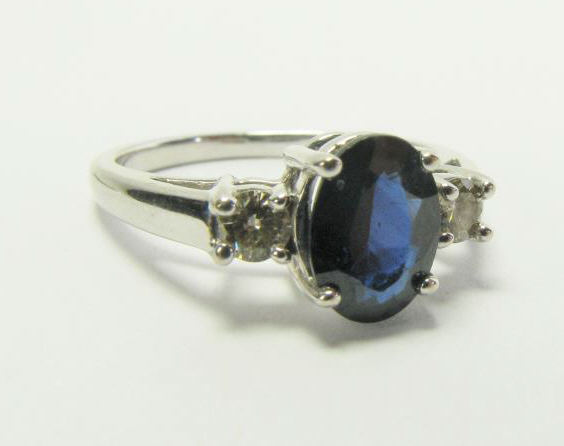 A 14K white gold three stone ring with 8 x
