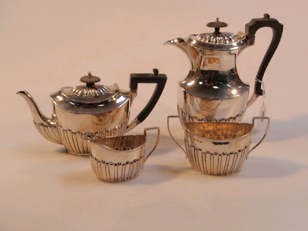 A Harlequin four piece silver tea set of part reeded