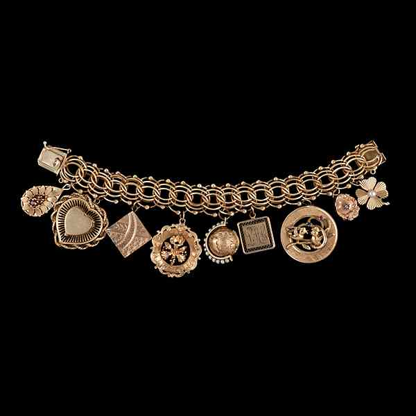 14k Gold Charm Bracelet 14k yellow gold charm bracelet containing