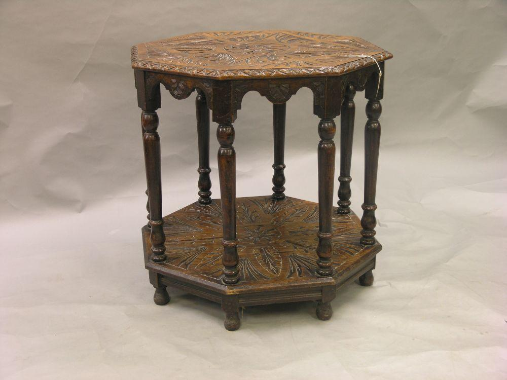 A late Victorian dark carved oak centre table octagonal shape