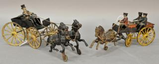 Two cast iron horse drawn wagons including one having a