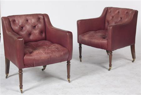 A pair of red leather button back arm chairs each