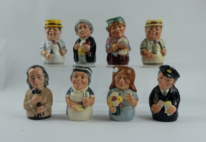A collection of Royal Doulton Doultonville toby jugs and candle