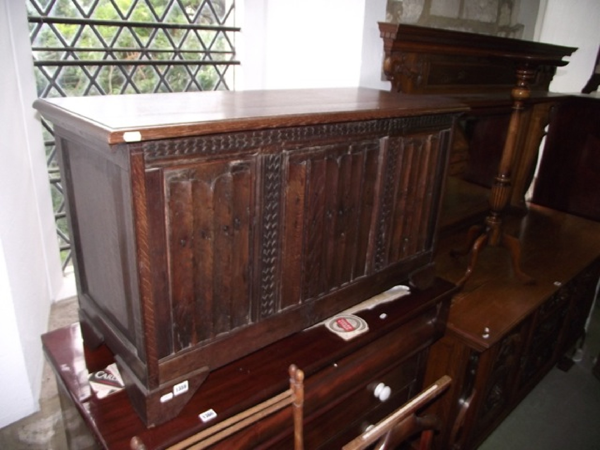 An oak coffer with hinged lid the front elevation enclosed