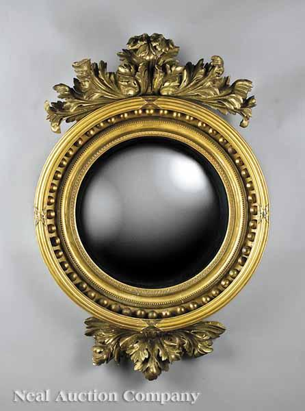 An English or American Carved Giltwood Bullseye Mirror c 1830