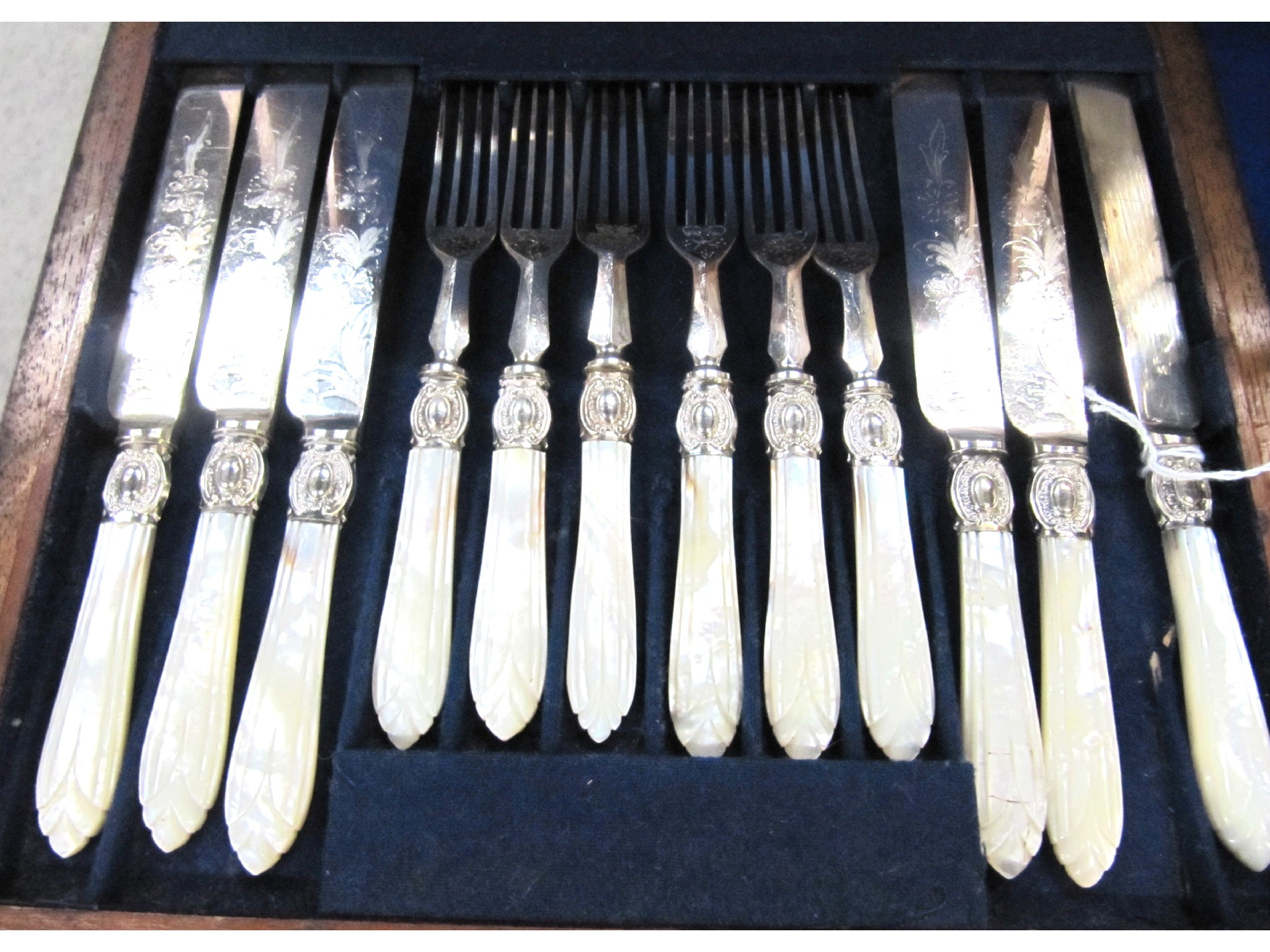 A cased part mother of pearl and EP dessert cutlery