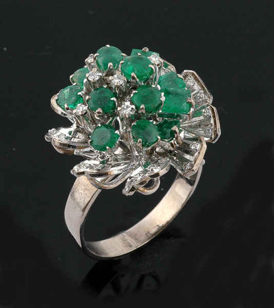 An emerald and diamond cluster ring The abstract cluster set