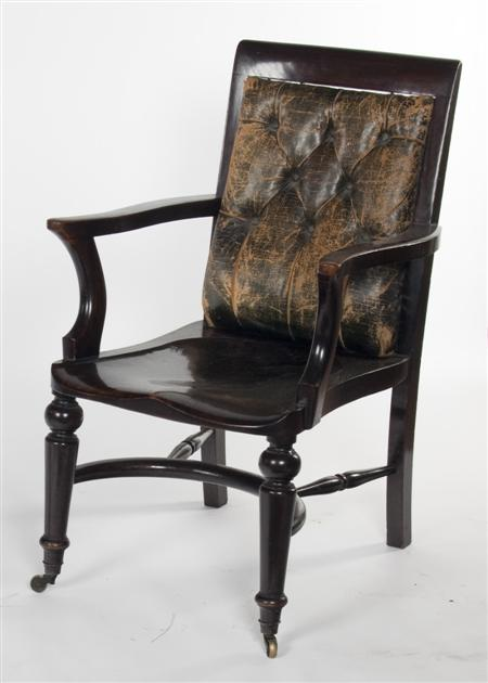 A late 19th century stained oak arm chair the leather