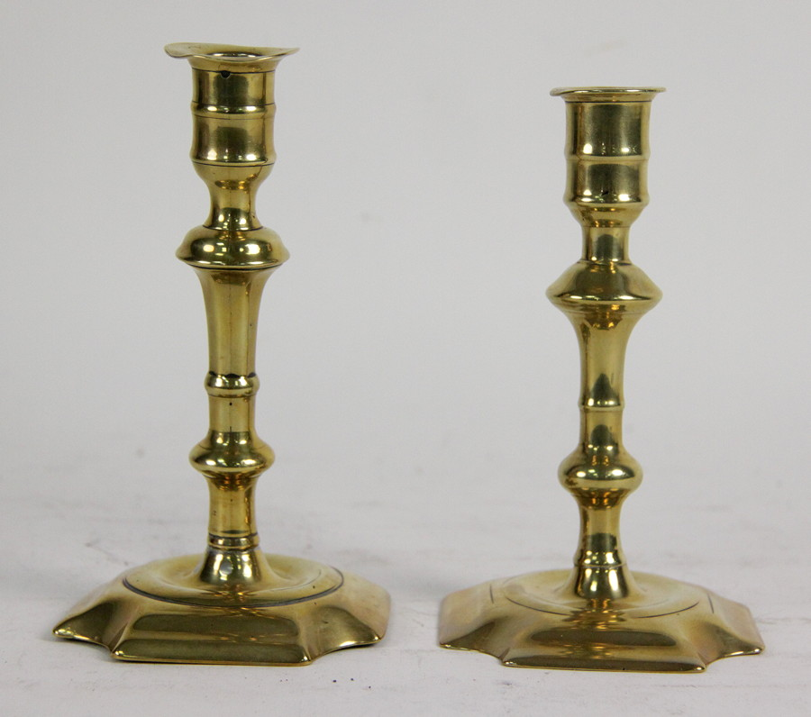 A near pair of Georgian brass candlesticks each of knopped