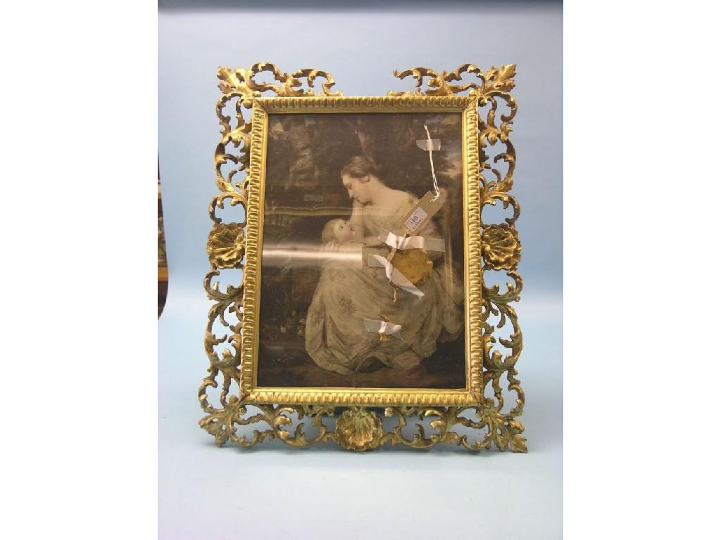 A 19th century Florentine giltwood picture frame elaborately carved with