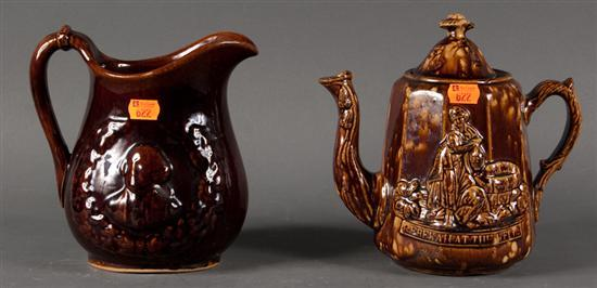 American Rockingham type relief decorated glazed pottery pitcher and a
