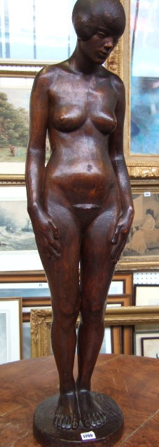 A Stinkwood carved sculpture of a female nude on integral