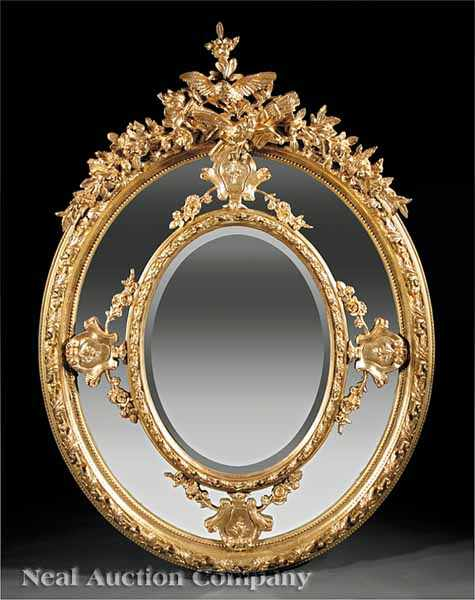 A Monumental Antique Louis XVI Style Carved Giltwood Mirror elaborate