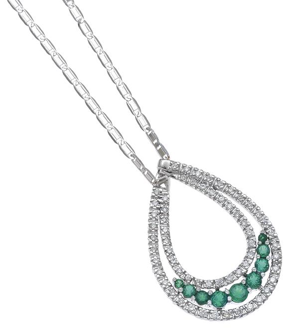 A COLOMBIAN EMERALD AND DIAMOND PENDANT Of open tear drop