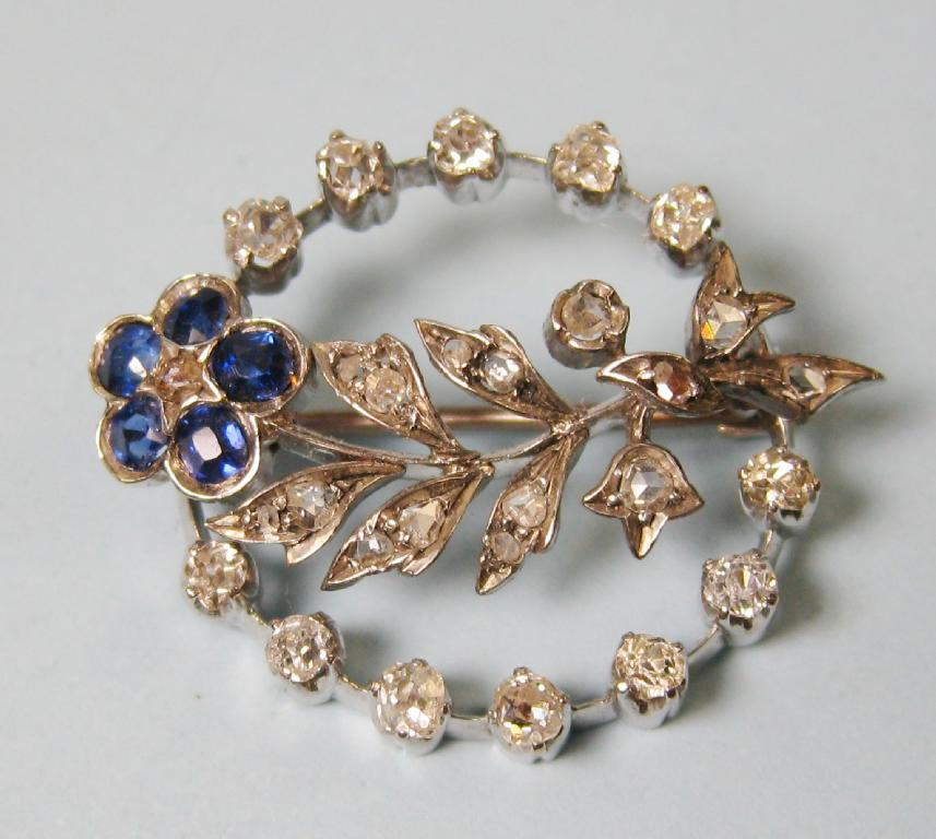 A circular Flower Brooch set twenty eight diamonds and five