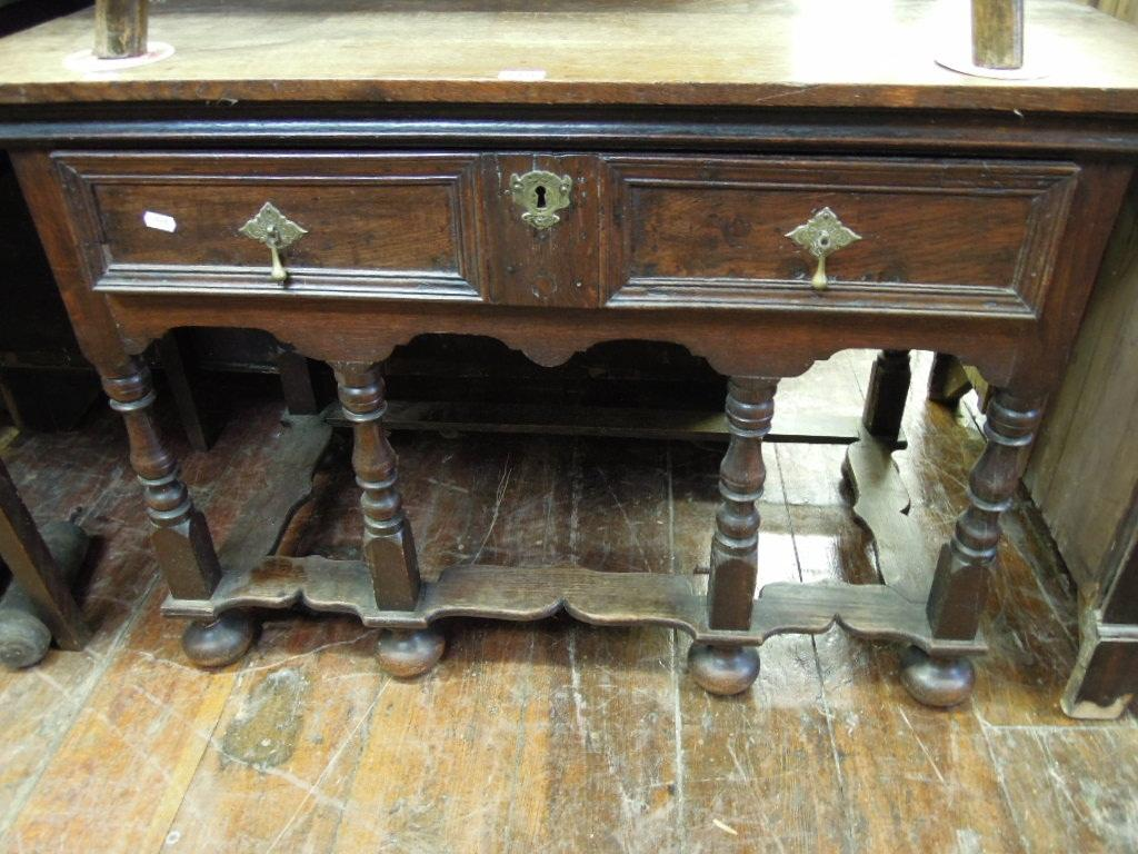 An antique oak side table stand in the William Mary