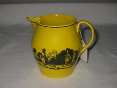 AN ENGLISH CANARY YELLOW JUG of bellied form black printed