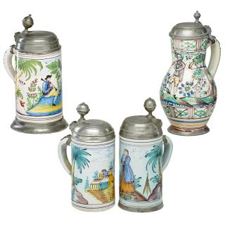 GROUPING OF FAIENCE STEINS Four One depicting a village with