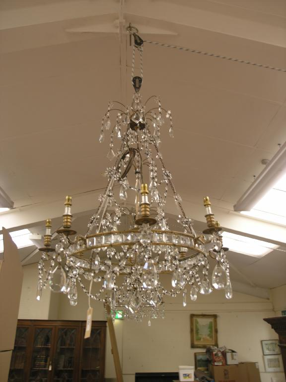 A pair of brass and cut glass chandeliers each with